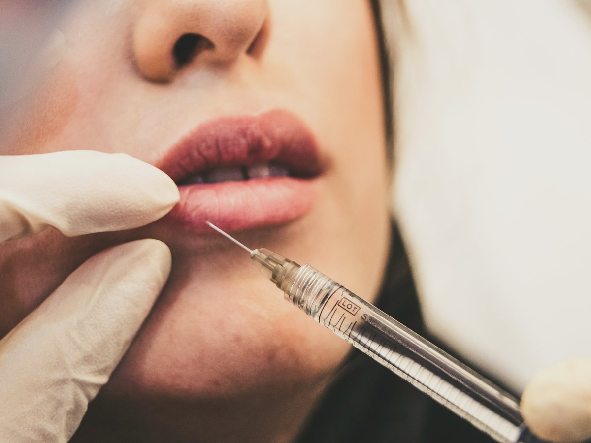 A practitioner giving a treatment in a clinic.